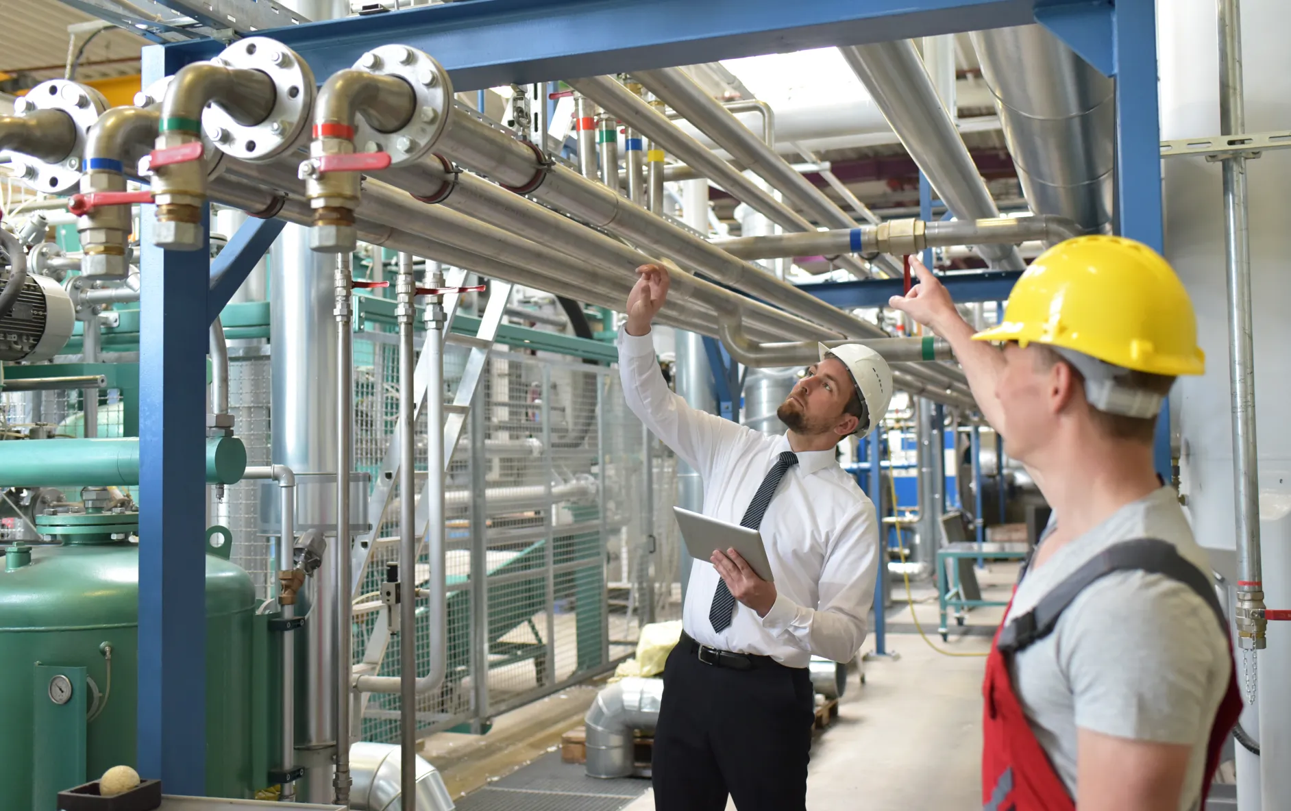FM service provider manager and technician inspecting facilities with Facilio CMMS